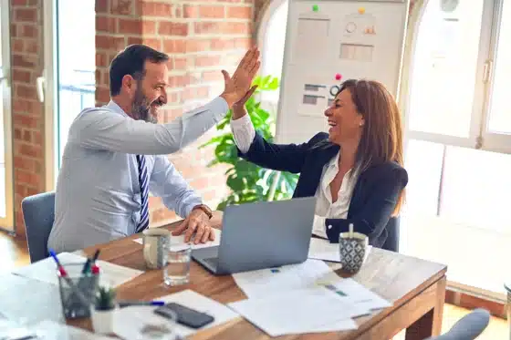 Mann und Frau - Erfolg im Business High Five